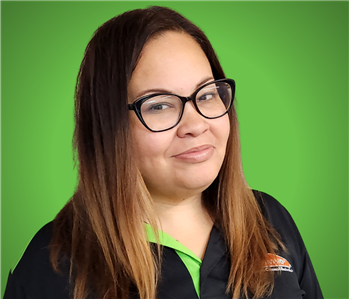 female in front of green background