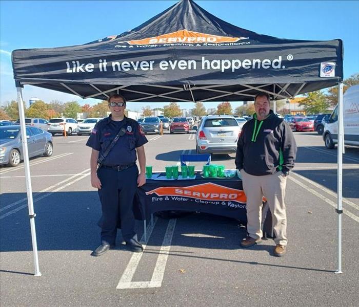 Servpro marketing team with tent and giveaway items