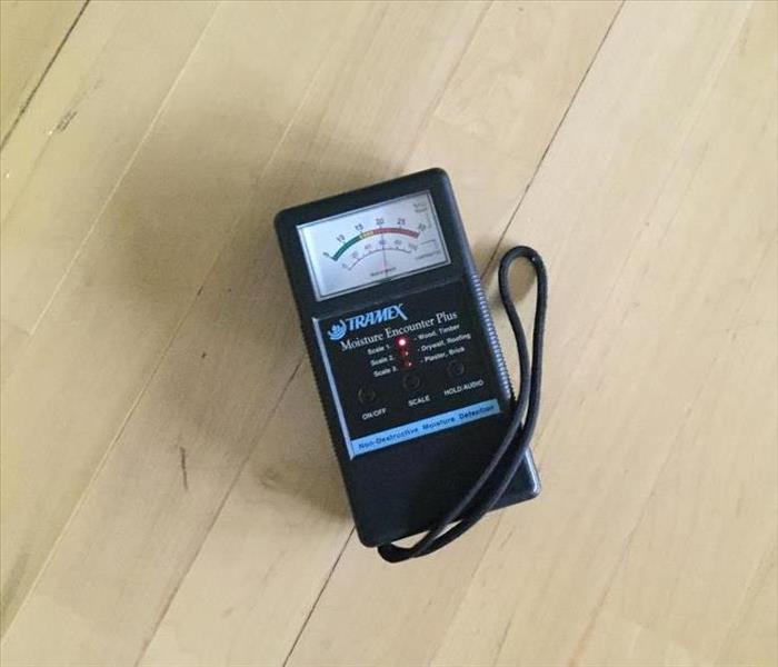 a moisture meter on a wooden floor